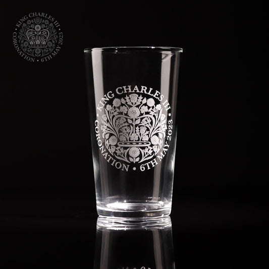 A beautiful pint glass engraved with the official emblem for the coronation of King Charles III the glass comes with a gift box which is also engraved with the same logo making it a great for any collection of royal memorabilia