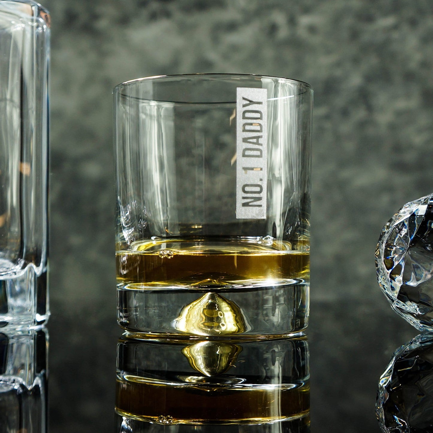 Man's hand holding a tumbler glass with personalised message that reads 'No1 Daddy' by Original Monkey Gifts.