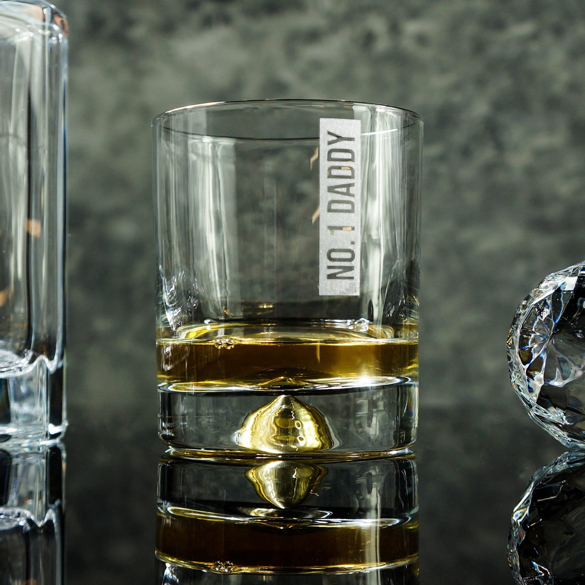 Man's hand holding a tumbler glass with personalised message that reads 'No1 Daddy' by Original Monkey Gifts.