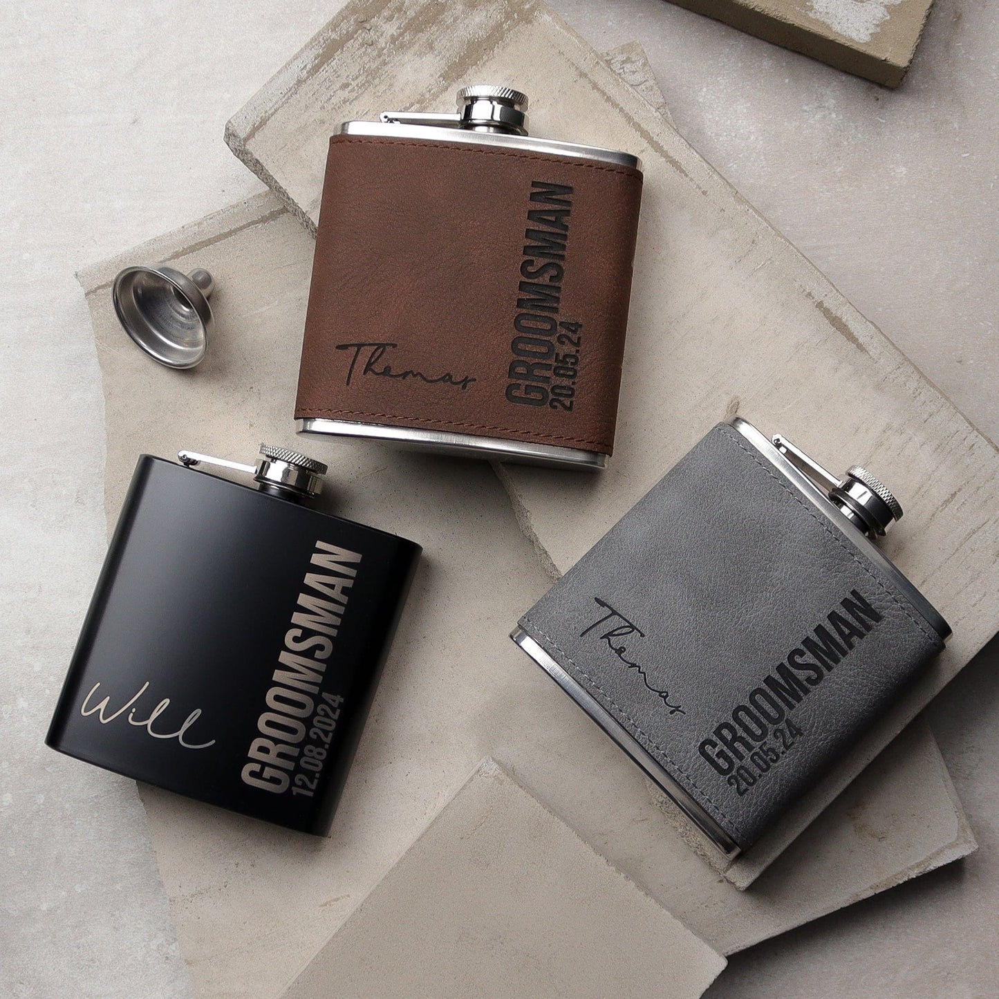 Picture of a 6oz stainless steel groomsmen hip flask wrapped in a Brown soft leather look material. The flask can be engraved with any role, name and date. The engraving comes through as black.