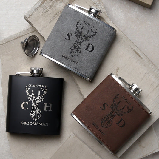 Set of three flasks all side by side one black, one grey, one brown all with a traditional design on the front with the recipients names, role and the wedding date all laser engraved. the perfect wedding groomsman gift.